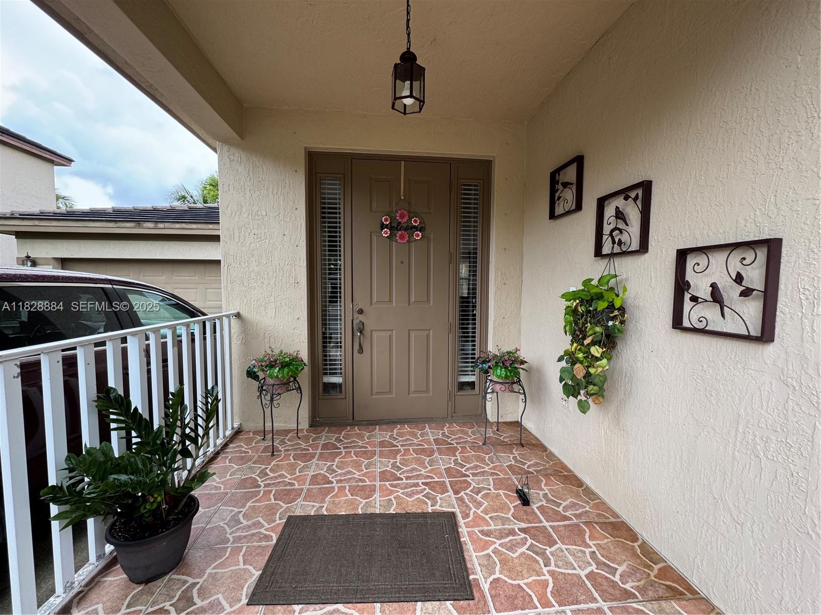20233 Southwest 128th Place Miami, FL 33177 - Photo 4 of 21 a view of a hallway with wooden floor and a potted plant