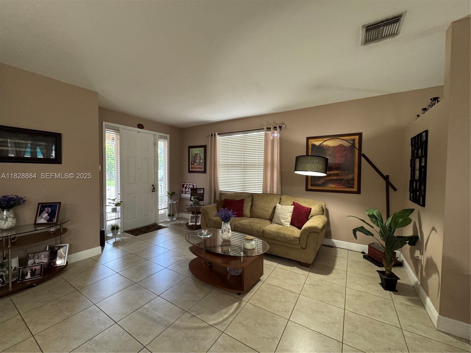 20233 Southwest 128th Place Miami, FL 33177 - Photo 7 of 21 a living room with furniture and a potted plant