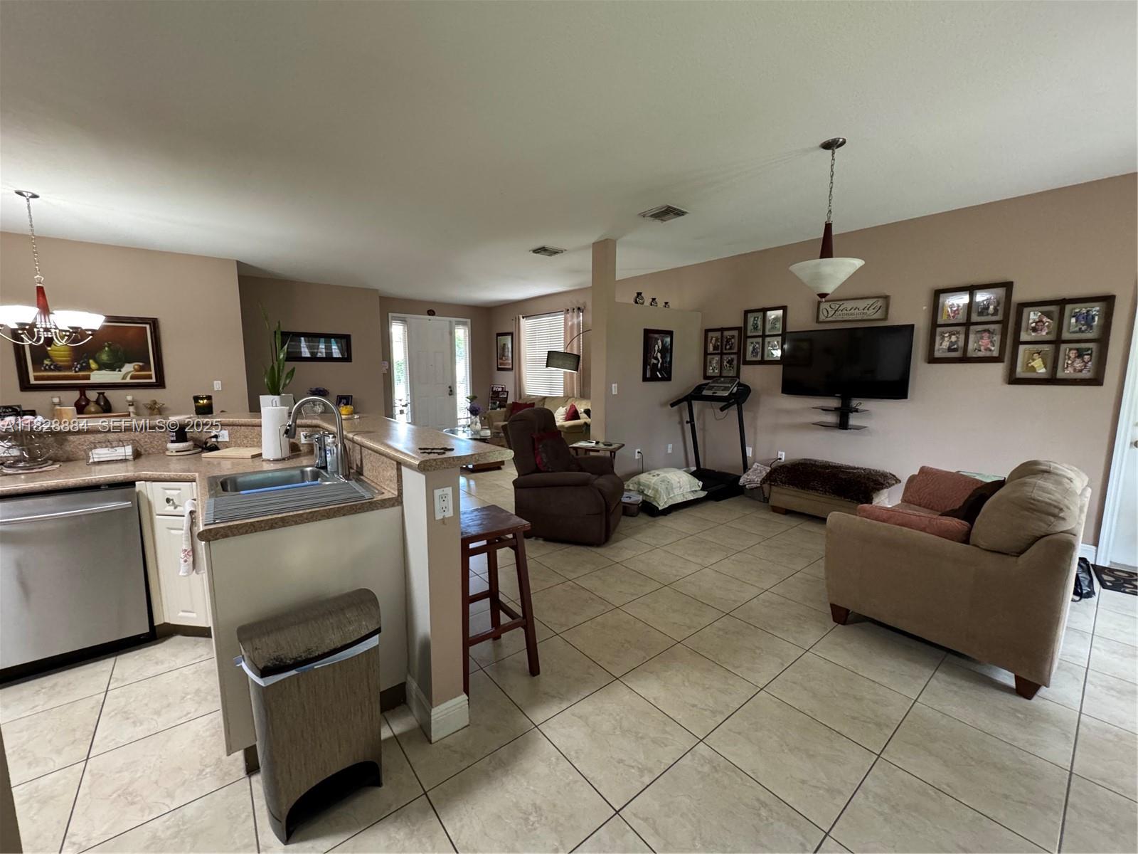 20233 Southwest 128th Place Miami, FL 33177 - Photo 9 of 21 a living room with furniture and a flat screen tv