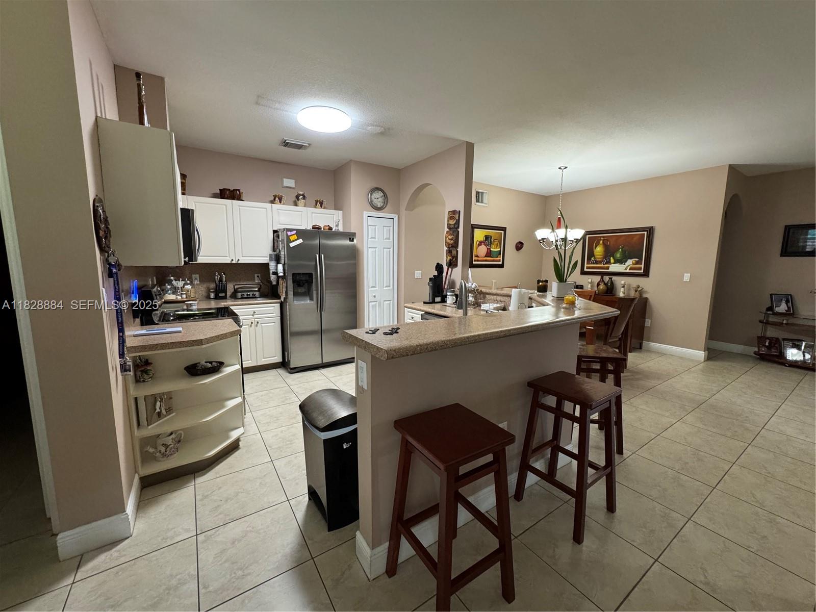 20233 Southwest 128th Place Miami, FL 33177 - Photo 10 of 21 a kitchen with stainless steel appliances a stove a sink refrigerator and microwave