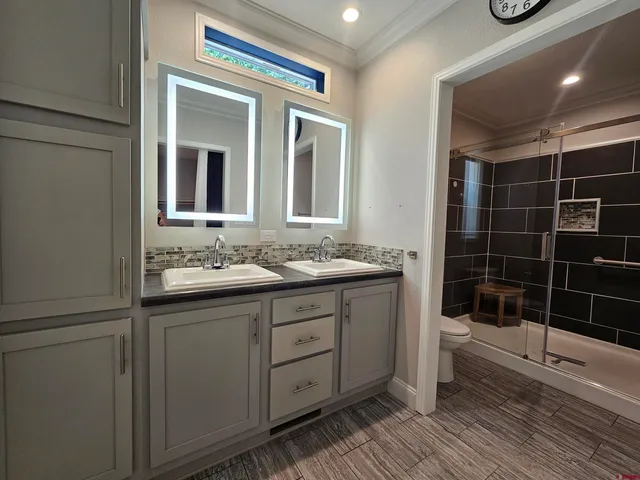 a bathroom with a double vanity sink and a mirror