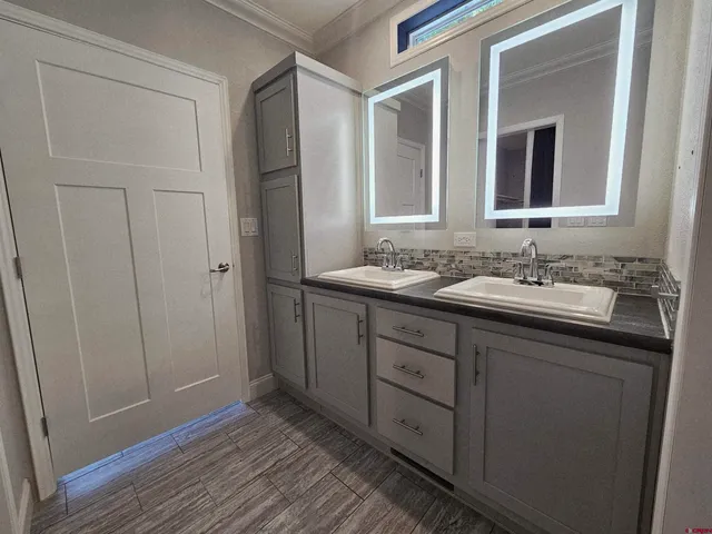 a bathroom with a double vanity sink and mirror
