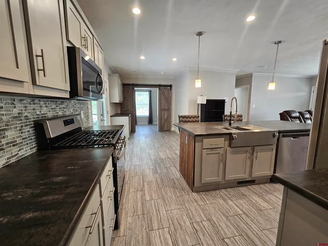 a kitchen with stove a sink and refrigerator