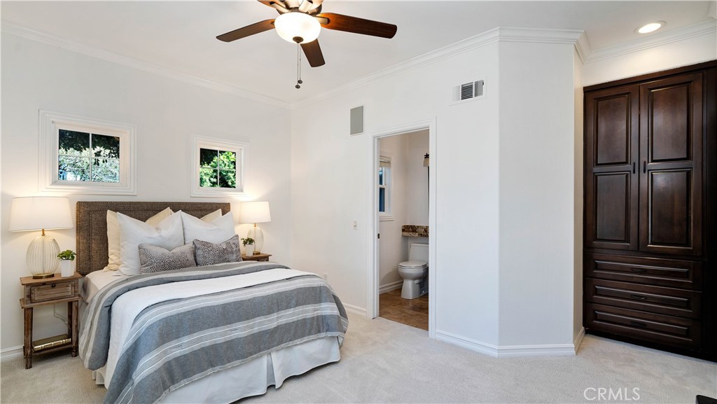 16 Bayleaf Lane Irvine, CA 92620 - Photo 16 of 66 a bedroom with a bed and a chandelier