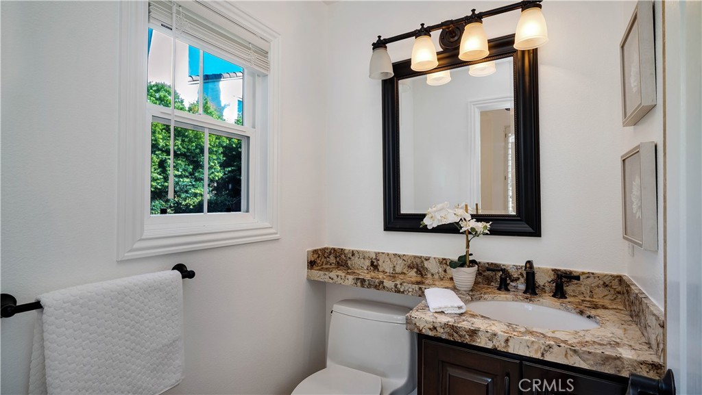 16 Bayleaf Lane Irvine, CA 92620 - Photo 17 of 66 a bathroom with a granite countertop sink and a mirror