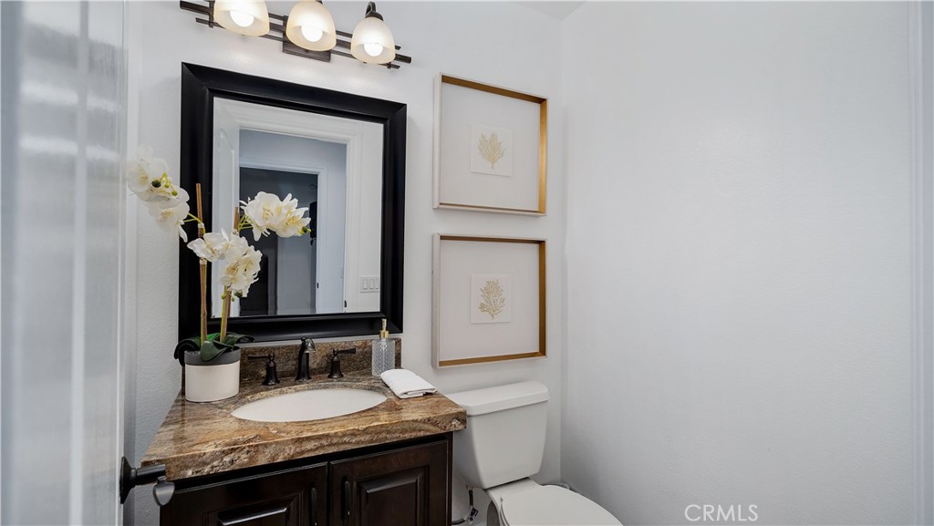 16 Bayleaf Lane Irvine, CA 92620 - Photo 19 of 66 a bathroom with a granite countertop sink vanity mirror and toilet