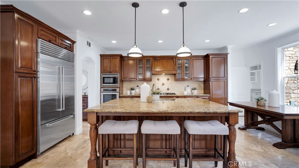 16 Bayleaf Lane Irvine, CA 92620 - Photo 22 of 66 a kitchen with stainless steel appliances granite countertop a kitchen island a stove and a refrigerator