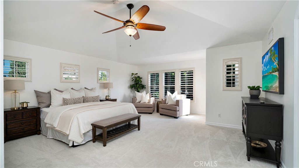 16 Bayleaf Lane Irvine, CA 92620 - Photo 39 of 66 a bedroom with a bed a couch and a flat tv screen on dresser