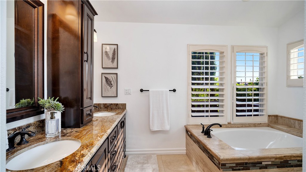16 Bayleaf Lane Irvine, CA 92620 - Photo 43 of 66 a bathroom with a tub a sink and a large mirror