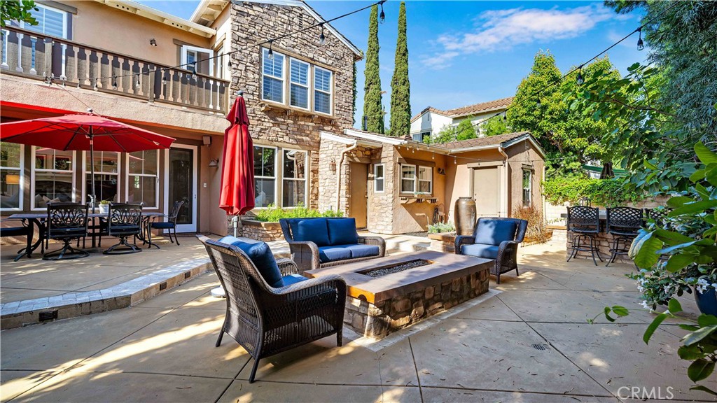 16 Bayleaf Lane Irvine, CA 92620 - Photo 48 of 66 a view of a patio with couches table and chairs under an umbrella