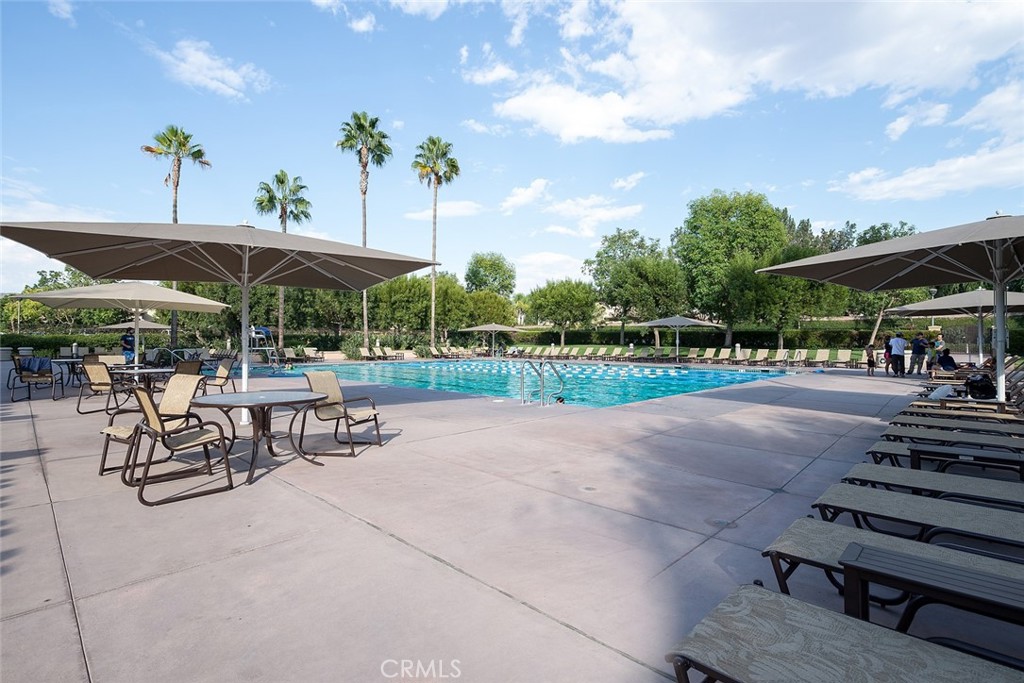 16 Bayleaf Lane Irvine, CA 92620 - Photo 63 of 66 a view of a patio with a table and chairs under an umbrella