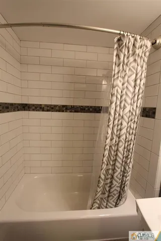 a bathroom with a bathtub and shower