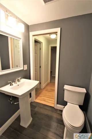a white toilet sitting next to a bathroom sink