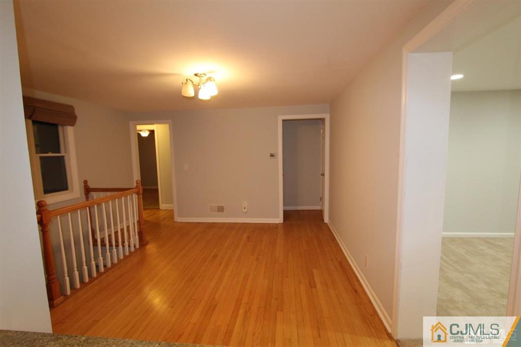 104 Grovers Mill Road Plainsboro, NJ 08536 - Photo 3 of 21 a view of a hallway with wooden floor