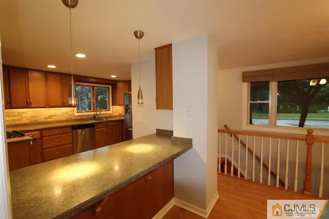 a kitchen with stainless steel appliances granite countertop a sink and cabinets