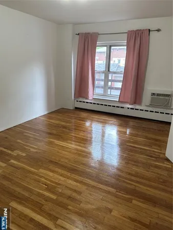 a view of room with wooden floor and fan