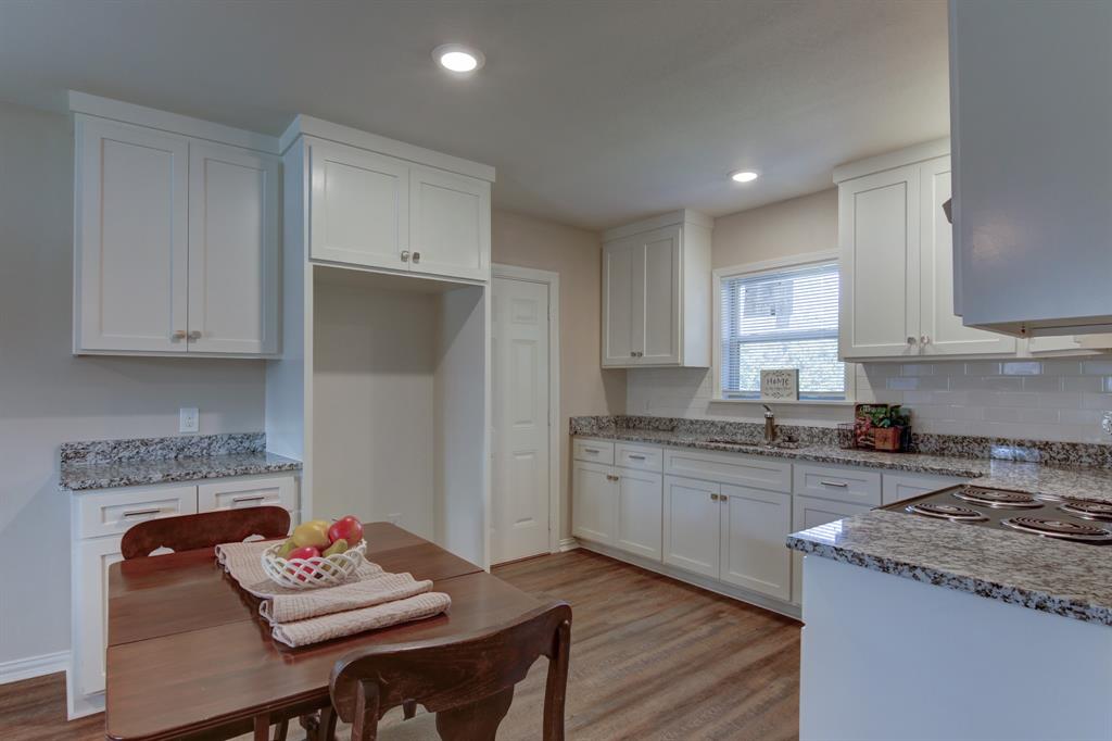 913 North 32nd Street Waco, TX 76707 - Photo 5 of 12 a kitchen with stainless steel appliances granite countertop a stove a sink dishwasher and a refrigerator with wooden floor