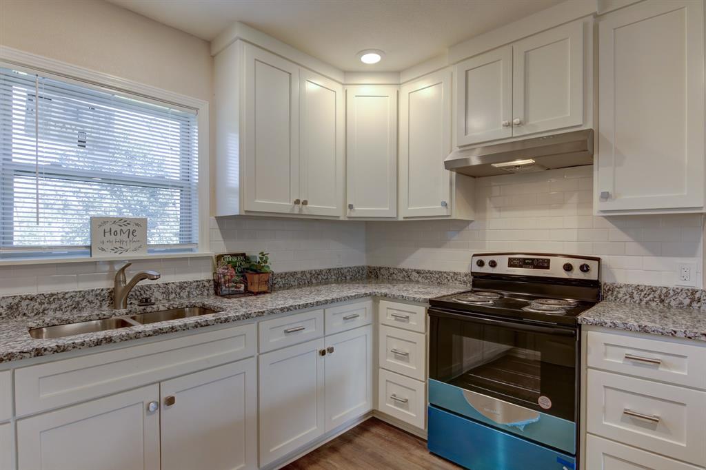 913 North 32nd Street Waco, TX 76707 - Photo 6 of 12 a kitchen with granite countertop white cabinets and appliances