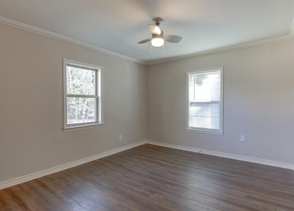 913 North 32nd Street Waco, TX 76707 - Photo 7 of 12 a view of an empty room with a window and wooden floor