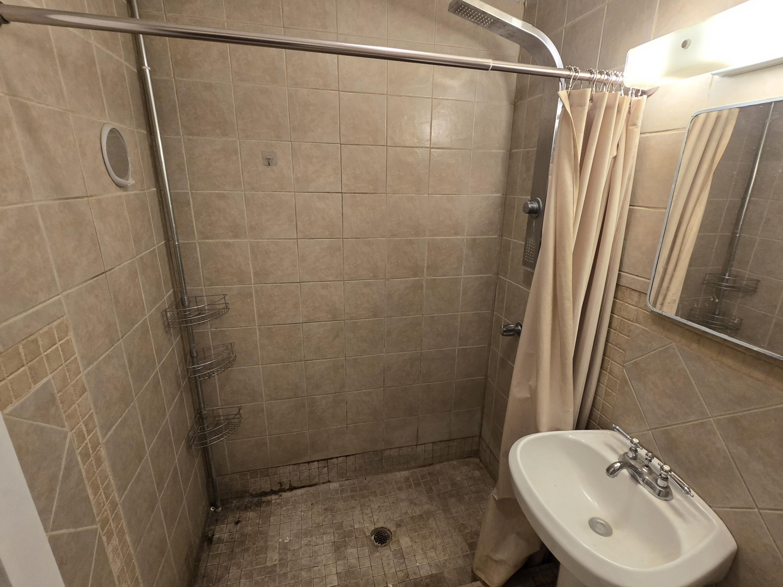 807 Northwest 8th Street Seminole, TX 79360 - Photo 13 of 15 a bathroom with a sink and shower