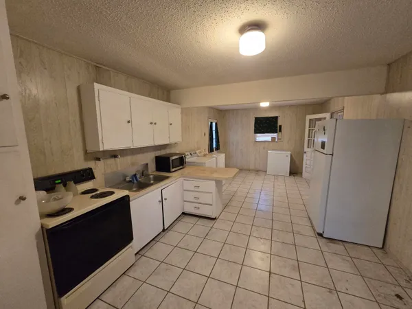 a kitchen with cabinets and white appliances