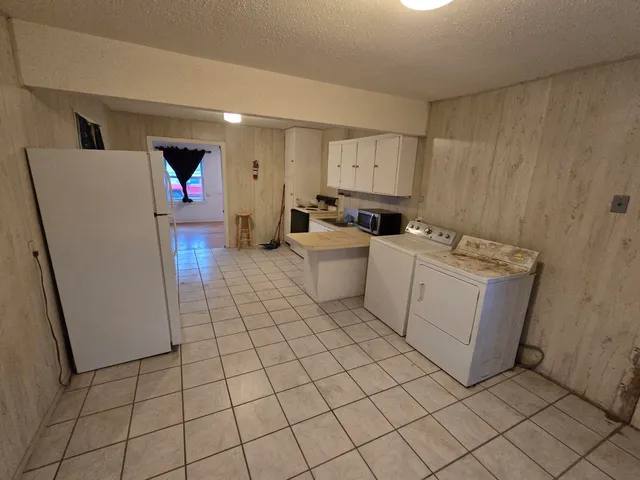 a view of a kitchen with storage and utility