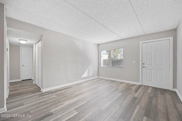 wooden floor in an empty room with a window