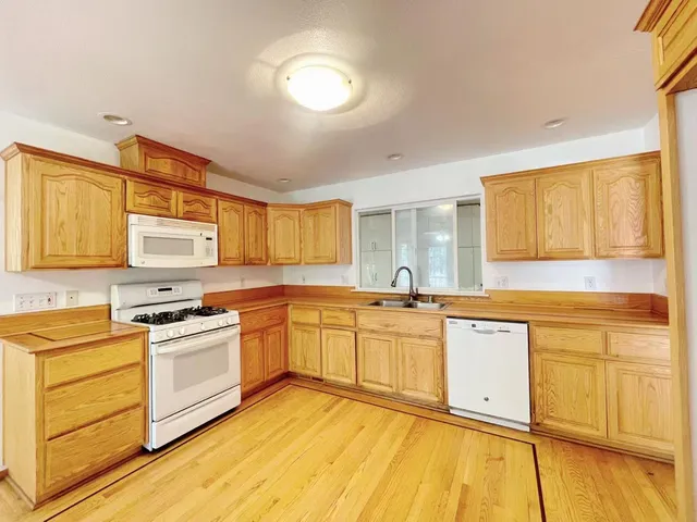 a kitchen with stainless steel appliances granite countertop a sink and cabinets