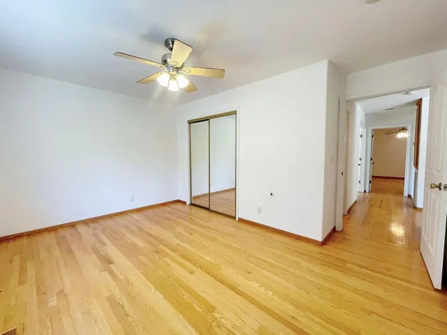 a bedroom with a bed and a potted plant