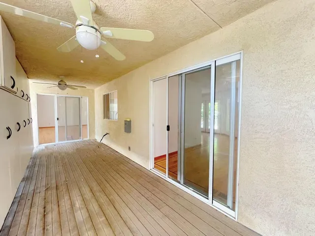 a view of a balcony with wooden fence and floor