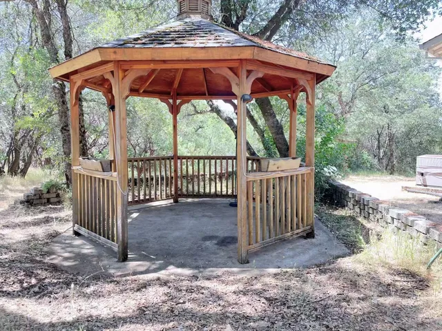 a backyard of a house with table and chairs