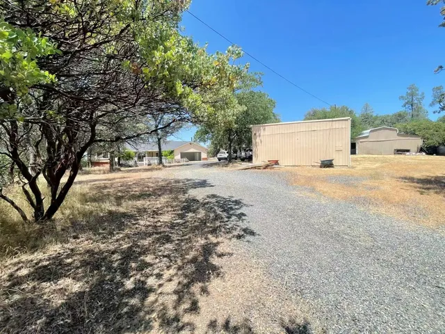 a view of a house with a yard and covered with snow in the yard