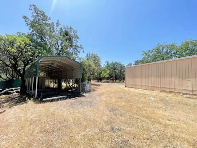 a view of a house with a yard and sitting area