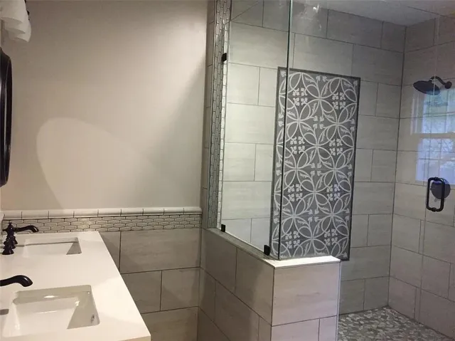 a bathroom with a bathtub and shower