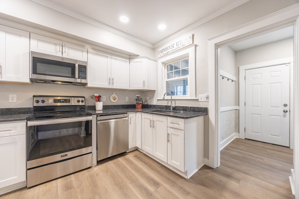 557 Dedham Street Wrentham, MA 02093 - Photo 15 of 42 a kitchen with stainless steel appliances granite countertop a stove a sink and a microwave