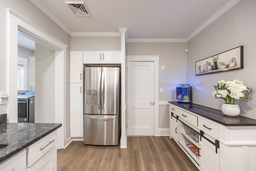 557 Dedham Street Wrentham, MA 02093 - Photo 18 of 42 a kitchen with stainless steel appliances a sink cabinets and wooden floor