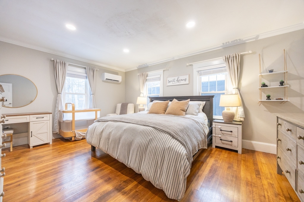 557 Dedham Street Wrentham, MA 02093 - Photo 21 of 42 a bedroom with a bed and wooden floor