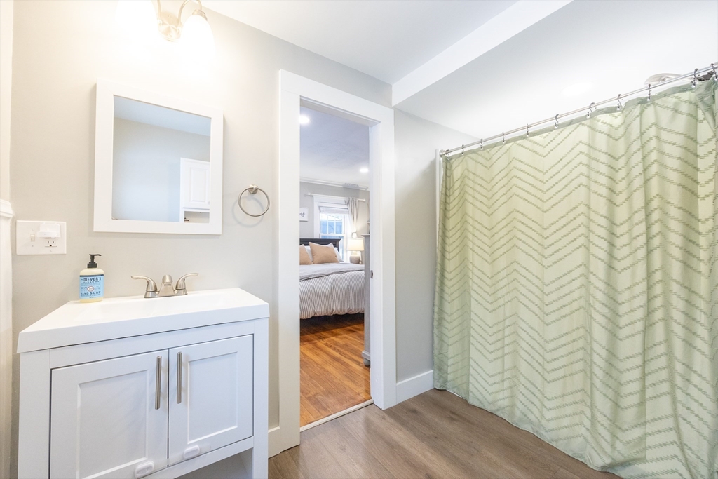 557 Dedham Street Wrentham, MA 02093 - Photo 26 of 42 a bathroom with a sink a mirror and a shower