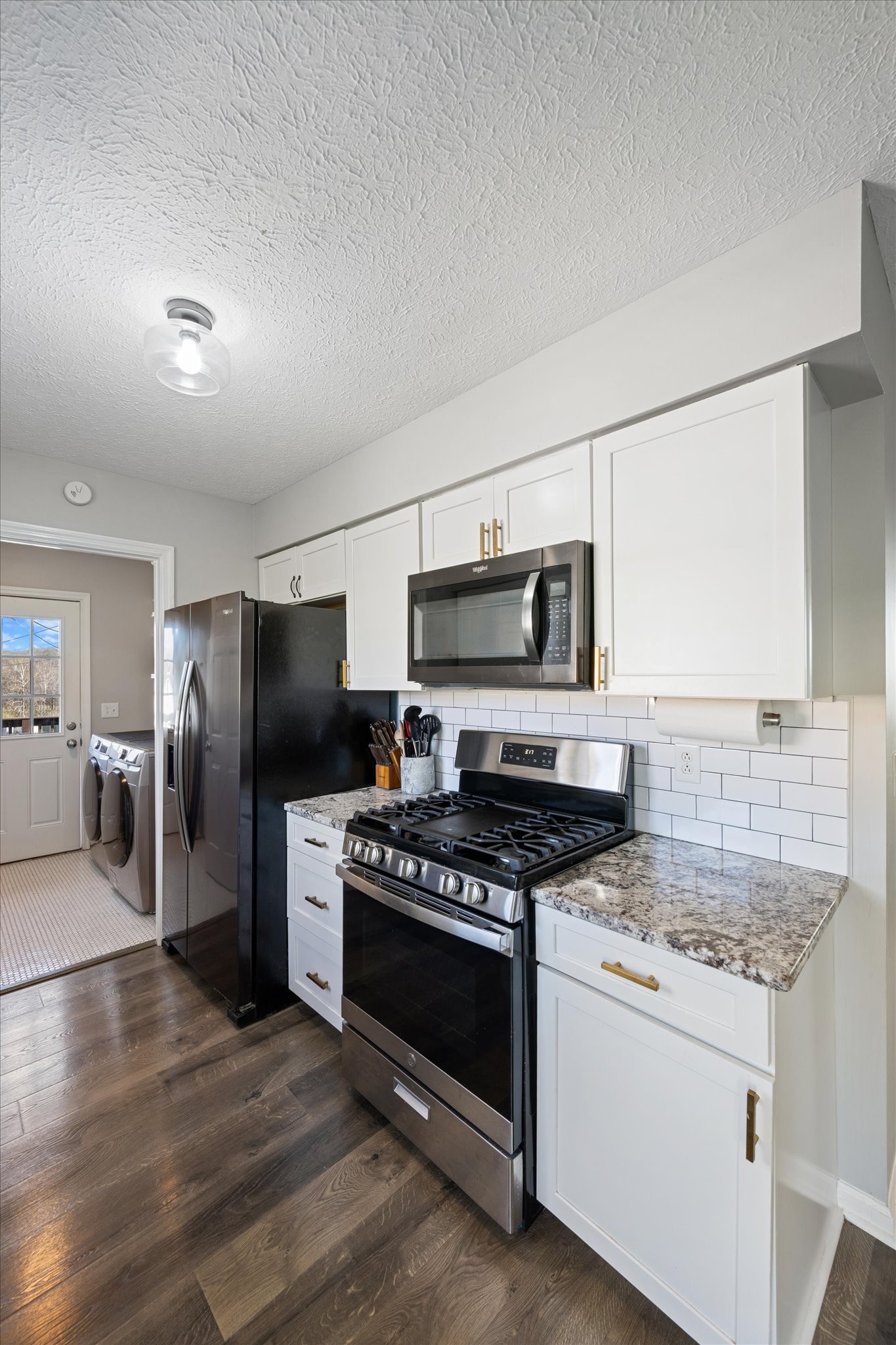 3695 Armstrong Road Springfield, TN 37172 - Photo 29 of 36 a kitchen with stainless steel appliances granite countertop a stove a refrigerator and a microwave