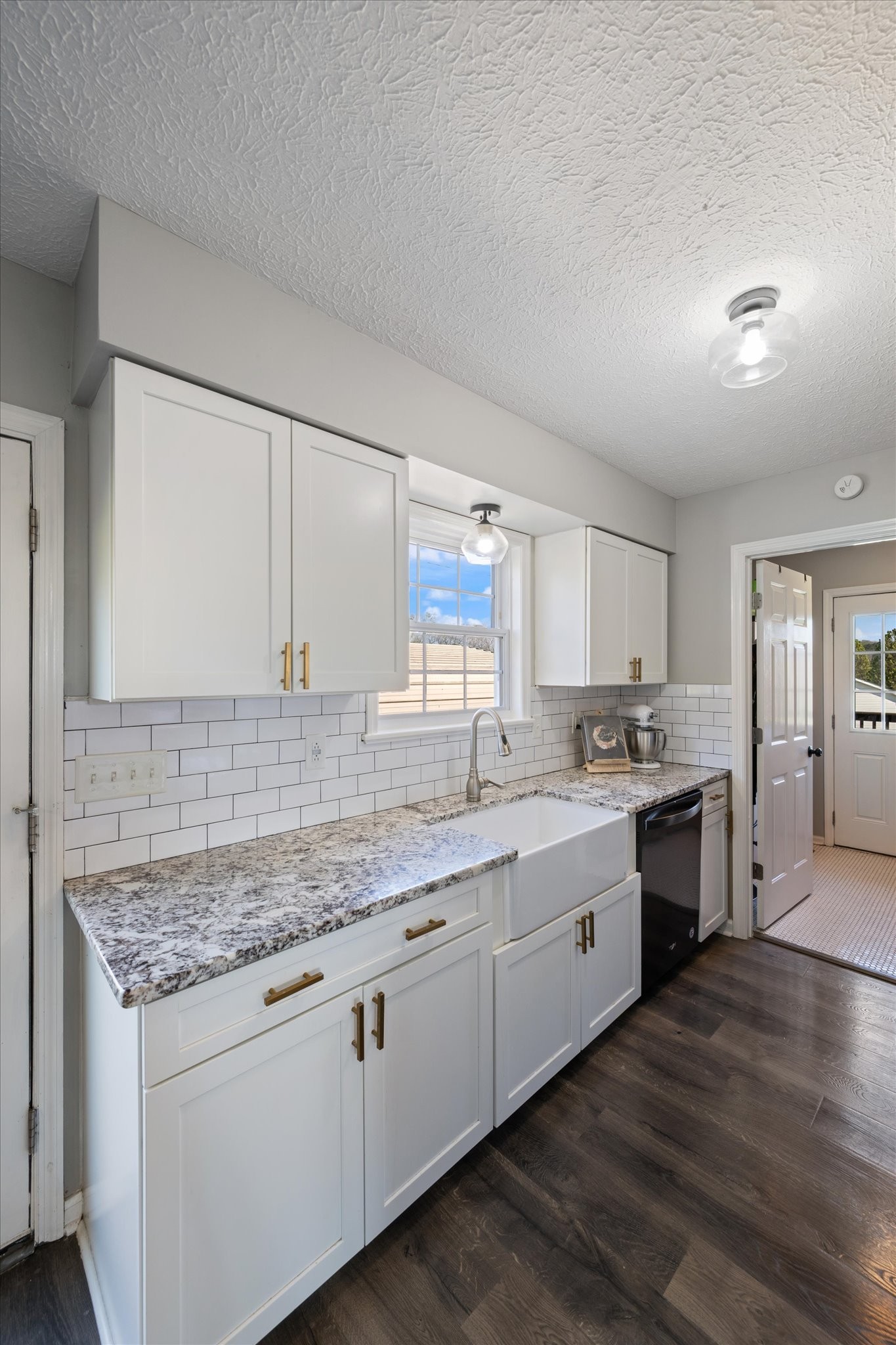 3695 Armstrong Road Springfield, TN 37172 - Photo 30 of 36 a kitchen with granite countertop white cabinets and white appliances