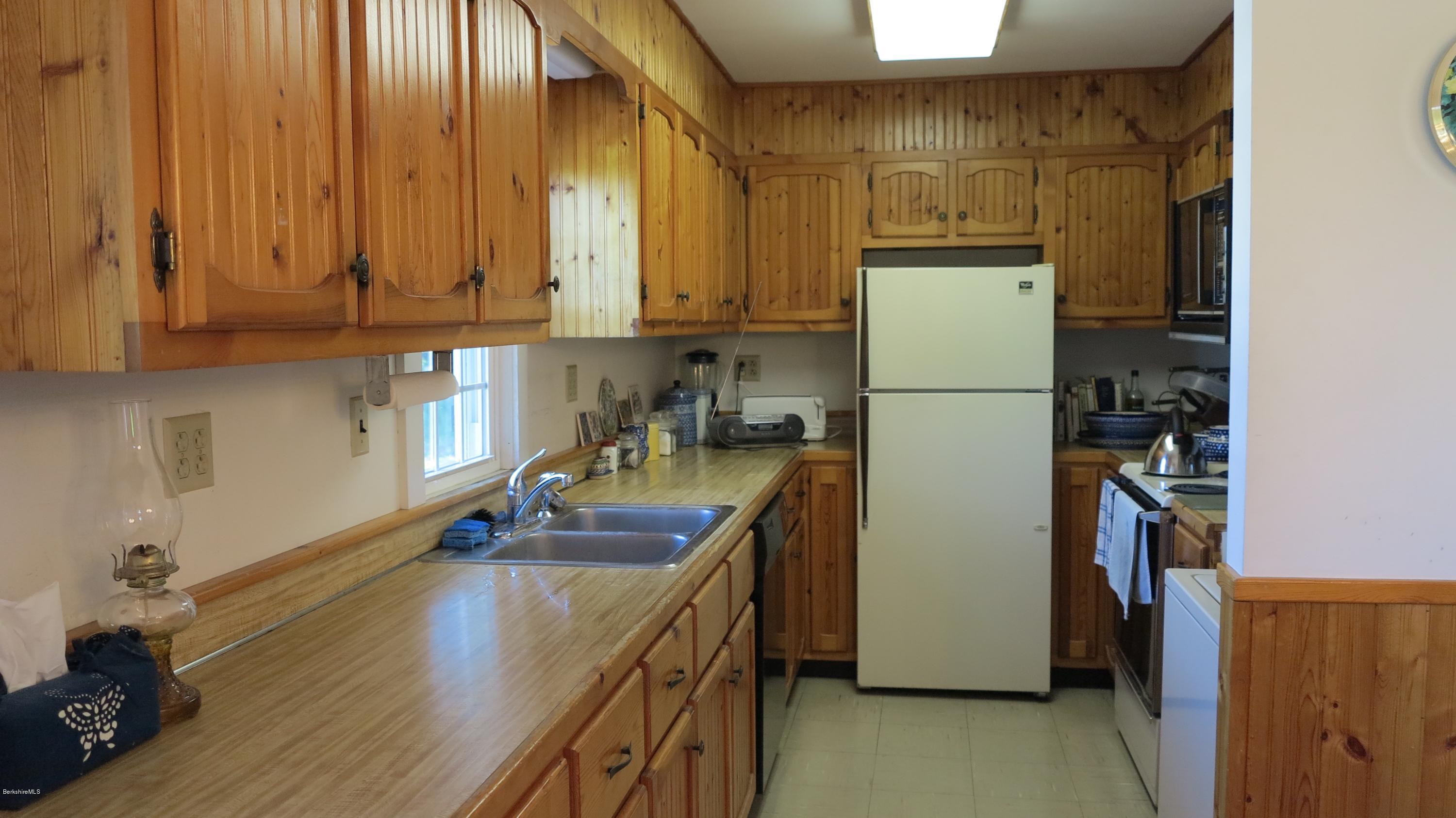 160 Cheever Road Richmond, MA 01254 - Photo 9 of 27 a kitchen with a sink a refrigerator and a stove