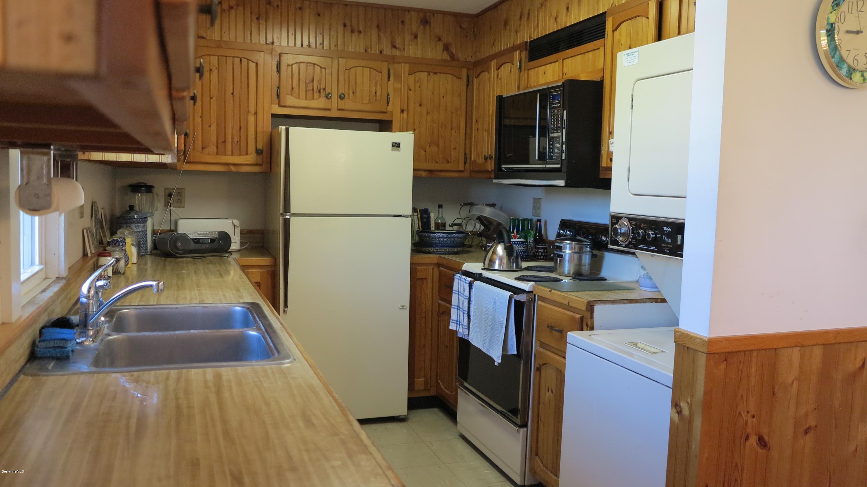 160 Cheever Road Richmond, MA 01254 - Photo 10 of 27 a kitchen with granite countertop a refrigerator a stove top oven a sink and dishwasher