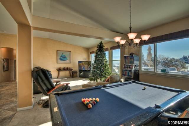 940 Flanders Road Reno, NV 89511 - Photo 6 of 9 a view of a dining room with furniture a chandelier and large windows