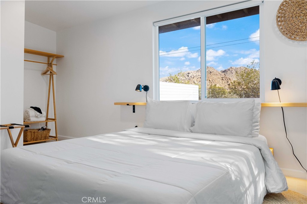 61879 Valley View Circle Joshua Tree, CA 92252 - Photo 18 of 63 a bedroom with a large bed and a large window