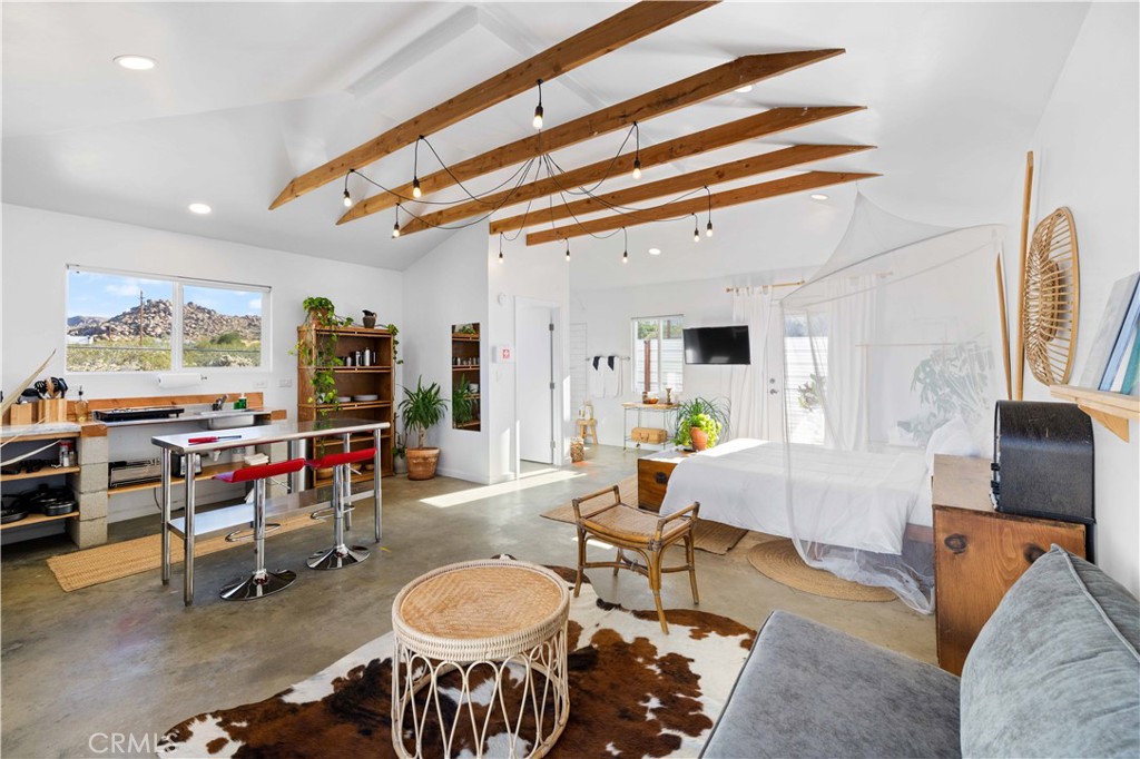 61879 Valley View Circle Joshua Tree, CA 92252 - Photo 23 of 63 a living room with furniture a dining table and chairs with wooden floor