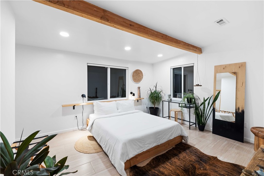 61879 Valley View Circle Joshua Tree, CA 92252 - Photo 42 of 63 a bedroom with a bed table and a flat screen tv