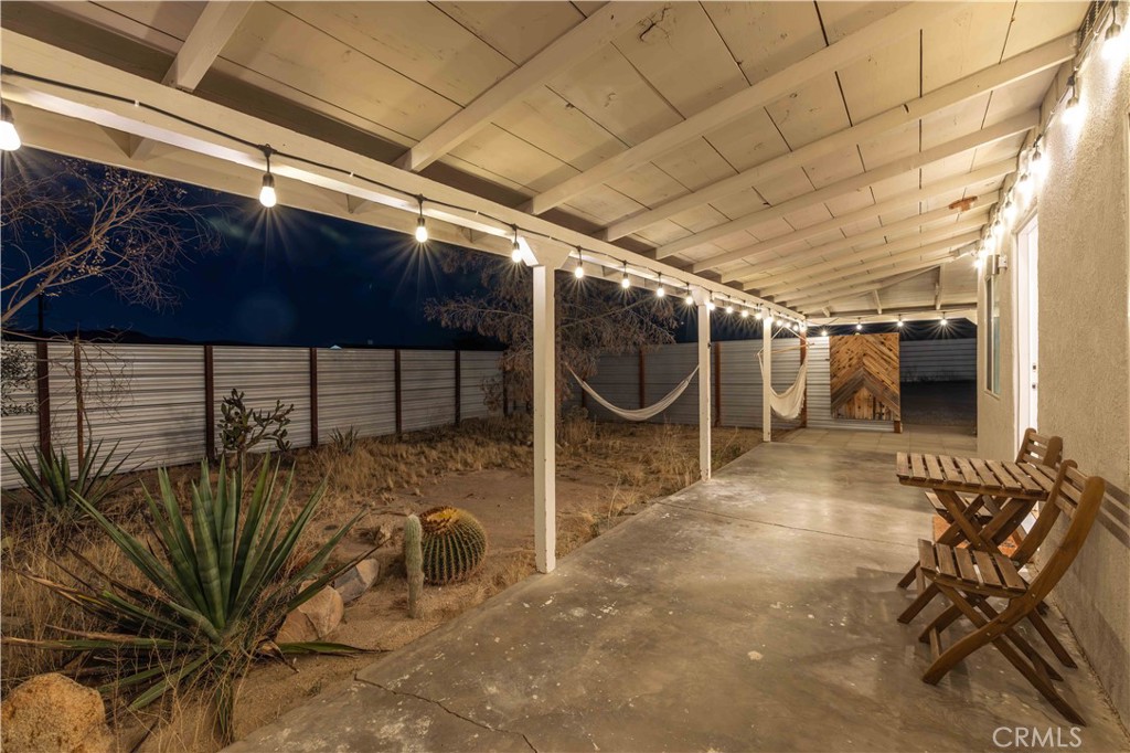 61879 Valley View Circle Joshua Tree, CA 92252 - Photo 44 of 63 a view of a porch with a table and chairs