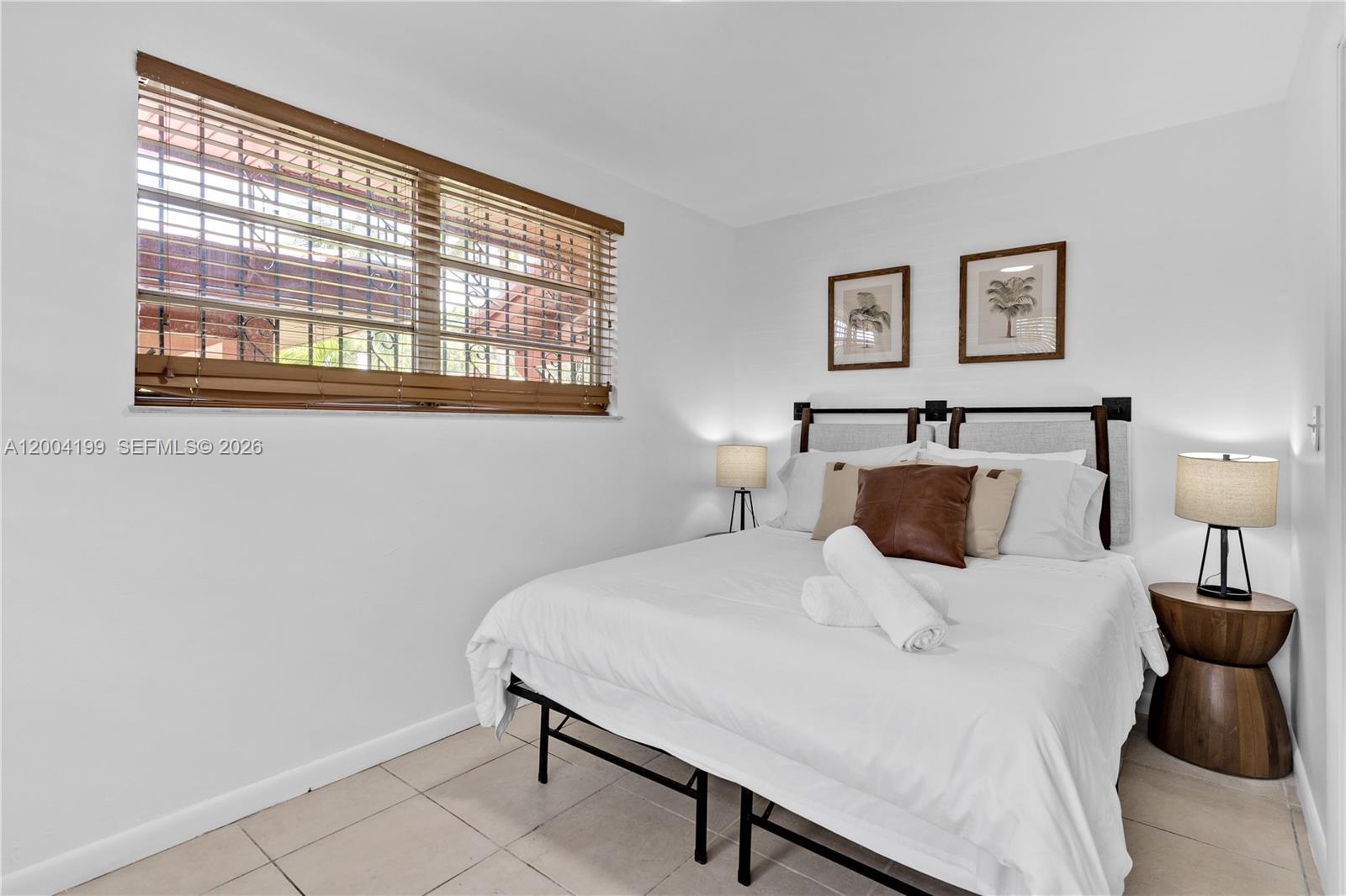 1841 Southwest 29th Avenue, Unit B Miami, FL 33145 - Photo 13 of 24 a bedroom with a bed and wooden floor