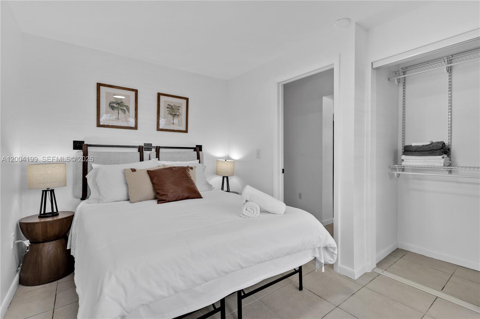 1841 Southwest 29th Avenue, Unit B Miami, FL 33145 - Photo 14 of 24 a bedroom with a bed and a lamp
