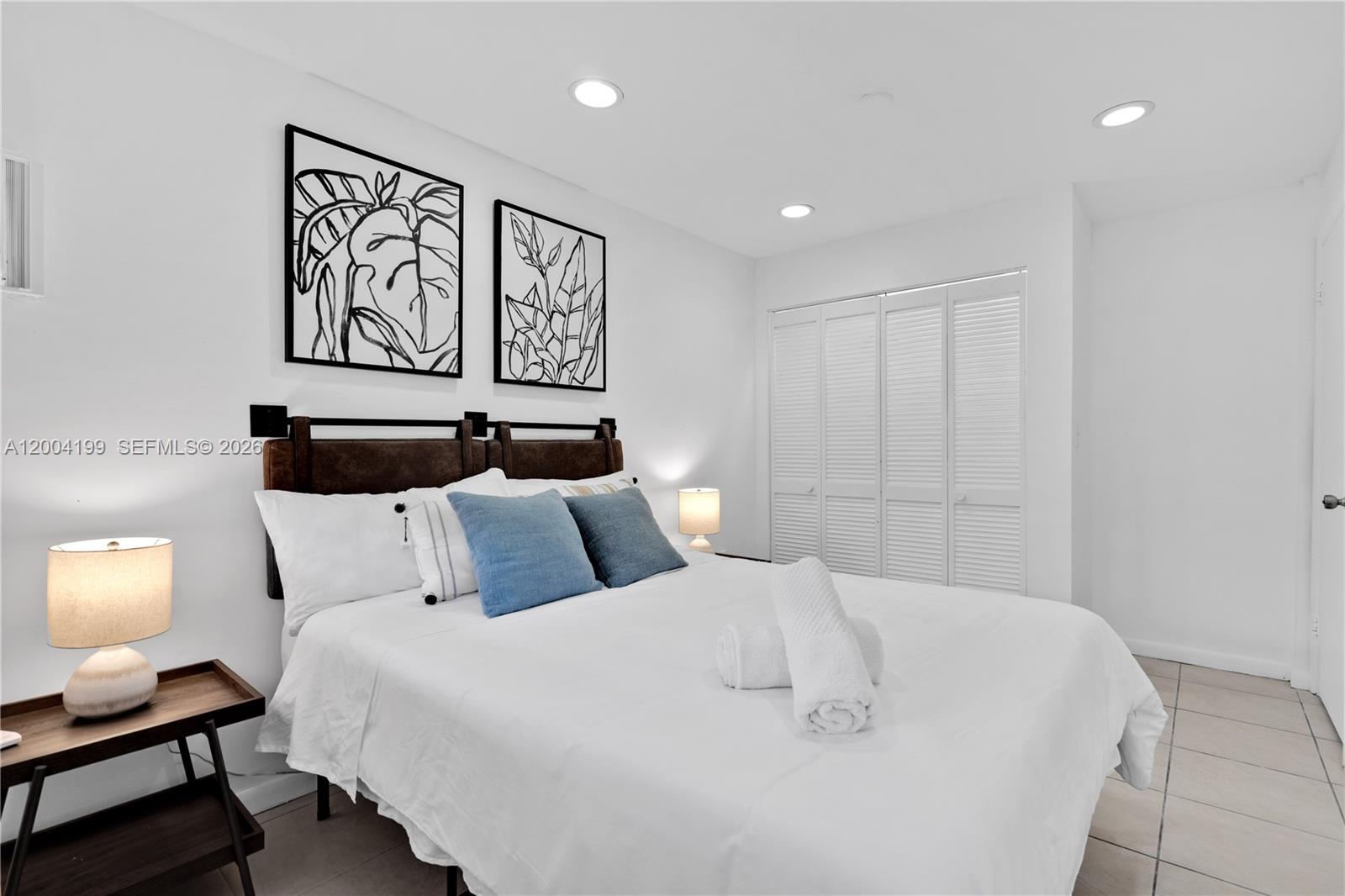 1841 Southwest 29th Avenue, Unit B Miami, FL 33145 - Photo 16 of 24 a bedroom with a bed and wall painting